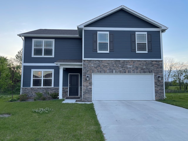 view of front of property with a garage and a front yard