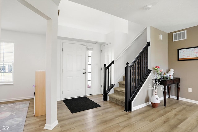 foyer featuring a wealth of natural light and light hardwood / wood-style flooring