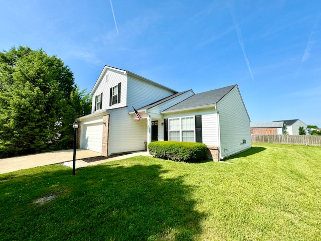 traditional home featuring brick siding, a front lawn, fence, a garage, and driveway