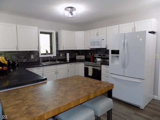 kitchen featuring white cabinets, white appliances, sink, dark wood-type flooring, and tasteful backsplash