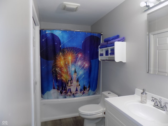 full bathroom featuring shower / bath combo, hardwood / wood-style floors, toilet, and vanity