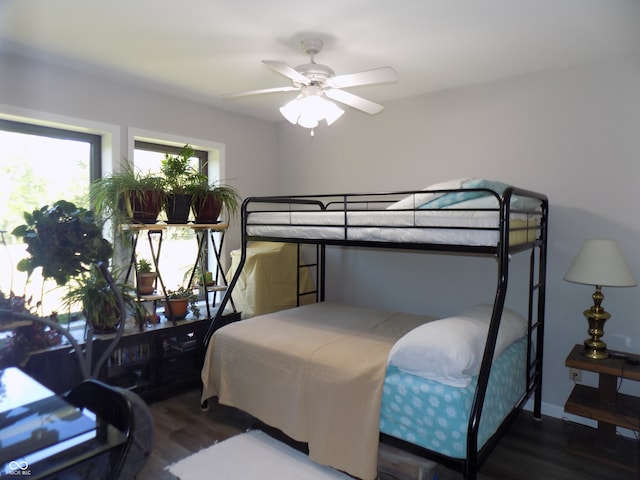 bedroom with ceiling fan and dark hardwood / wood-style floors