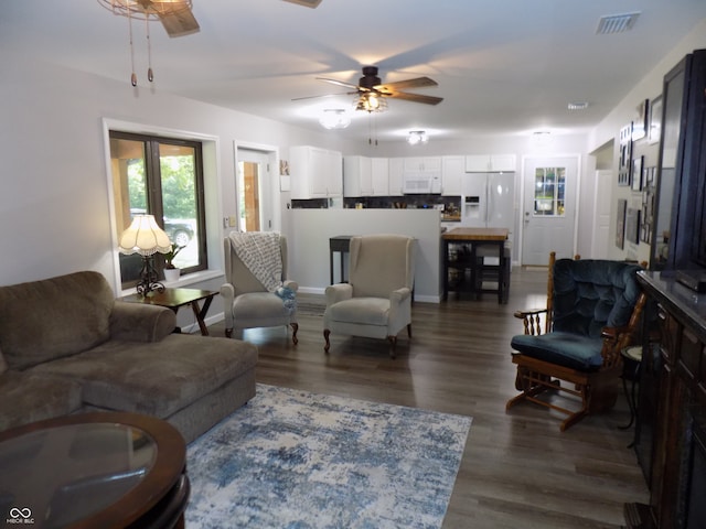 living room with dark wood-type flooring and ceiling fan