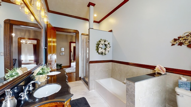 full bathroom featuring oversized vanity, double sink, tile floors, ornamental molding, and toilet