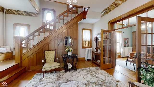 interior space with a high ceiling, a wealth of natural light, and hardwood / wood-style floors