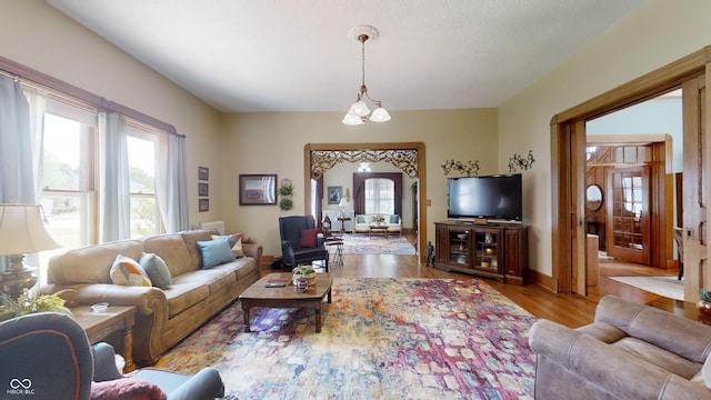 living room featuring an inviting chandelier and wood-type flooring