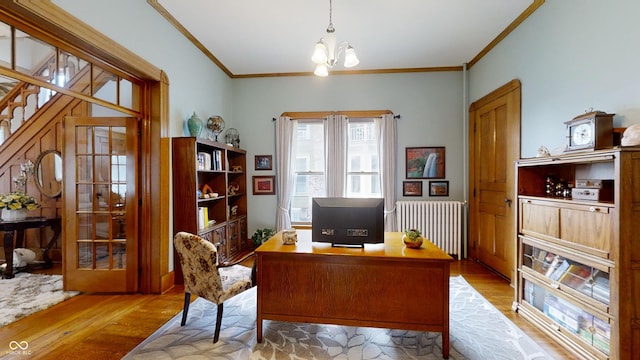 office with a notable chandelier, crown molding, radiator heating unit, and light wood-type flooring