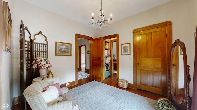 interior space with dark hardwood / wood-style floors and a notable chandelier