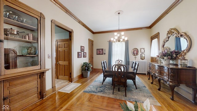 dining space featuring crown molding, radiator heating unit, and an inviting chandelier