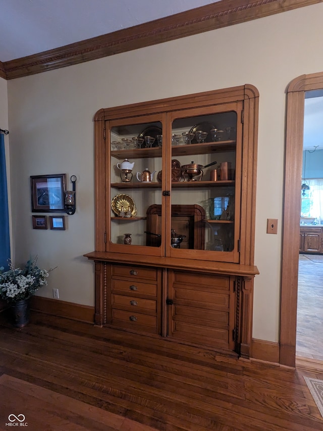 room details featuring ornamental molding and wood-type flooring