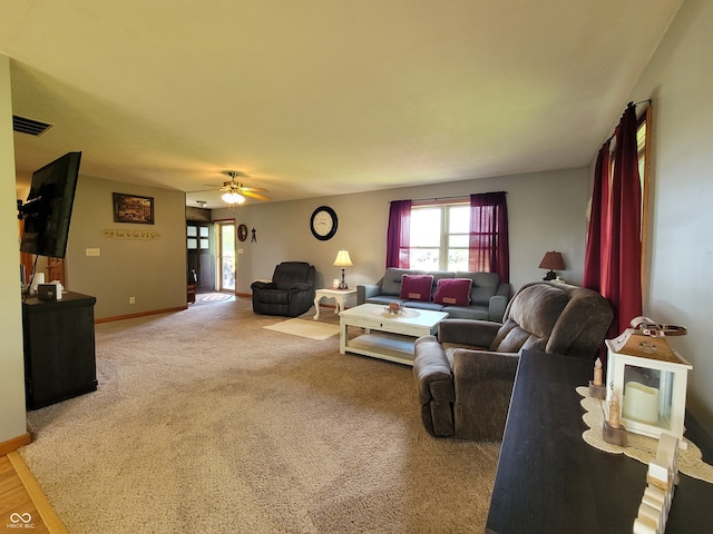 carpeted living room featuring ceiling fan