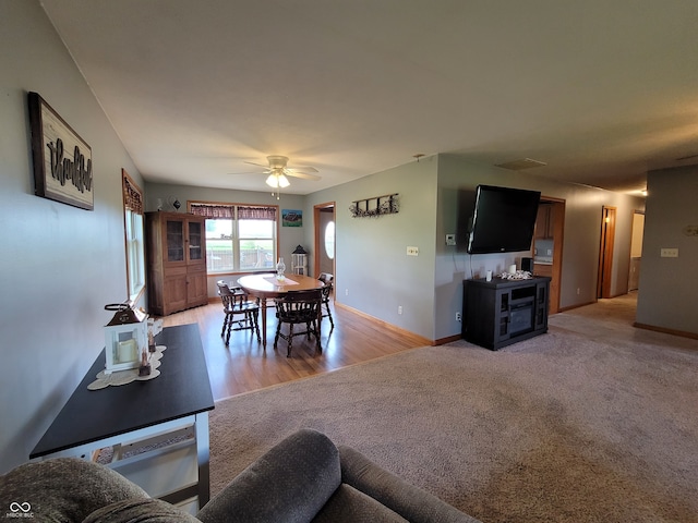 living room with light carpet and ceiling fan