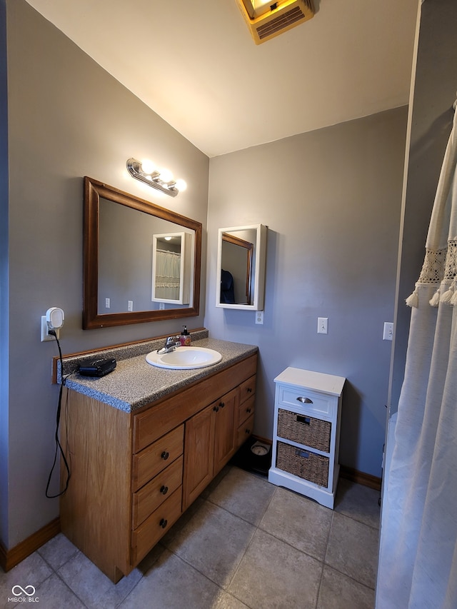 bathroom featuring tile floors and vanity