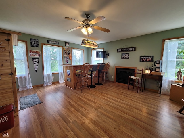 dining area featuring wood-type flooring and ceiling fan