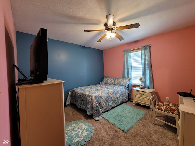 carpeted bedroom with a textured ceiling and ceiling fan