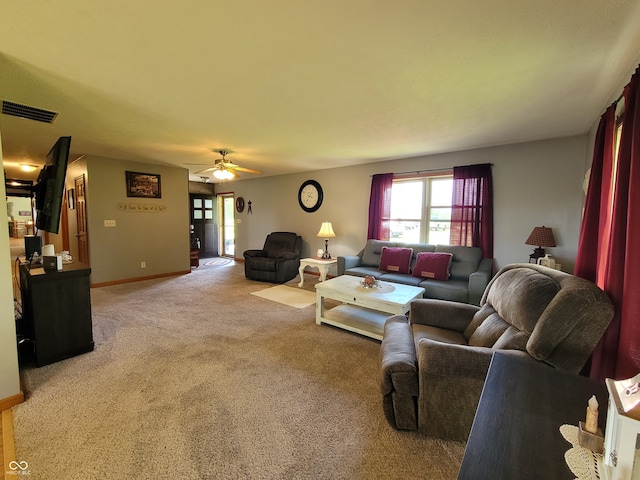 carpeted living room with ceiling fan