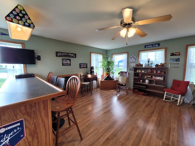 dining space with wood-type flooring and ceiling fan