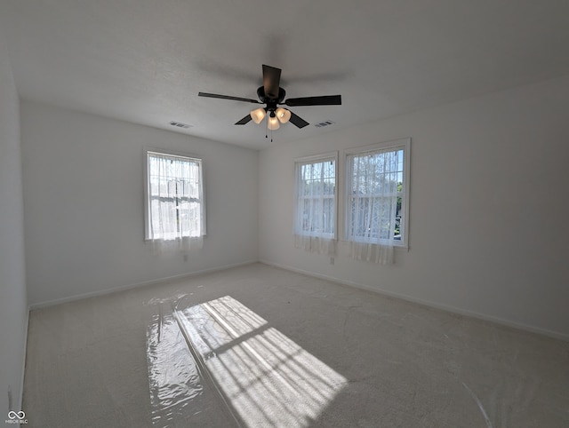 carpeted empty room featuring ceiling fan