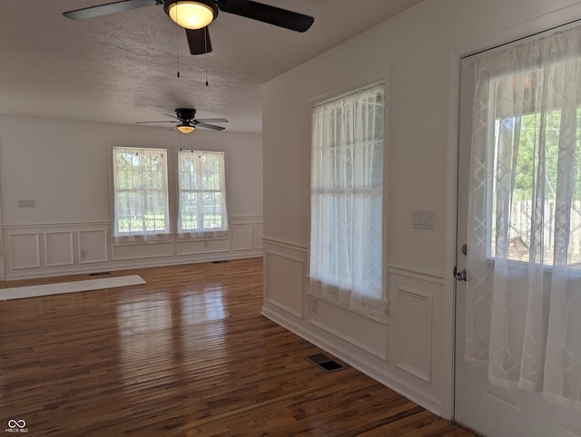 entrance foyer featuring a healthy amount of sunlight, ceiling fan, and hardwood / wood-style floors