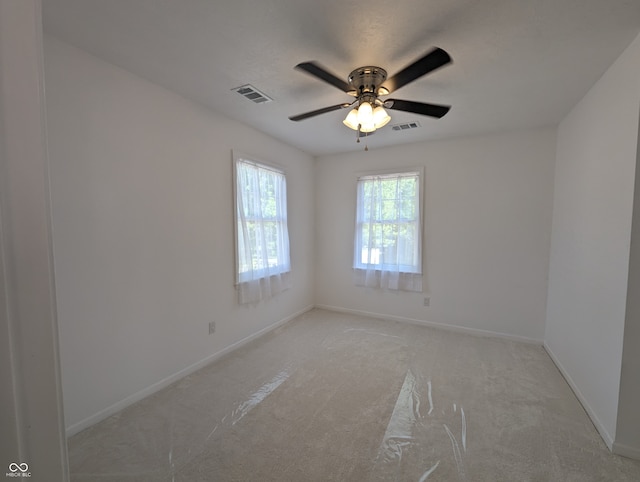 unfurnished room featuring ceiling fan and carpet flooring