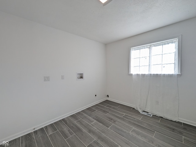 empty room featuring dark hardwood / wood-style flooring and a textured ceiling