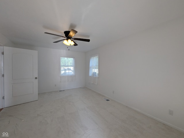 unfurnished room with carpet flooring and ceiling fan