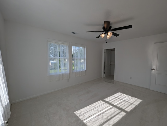 unfurnished room featuring carpet flooring and ceiling fan