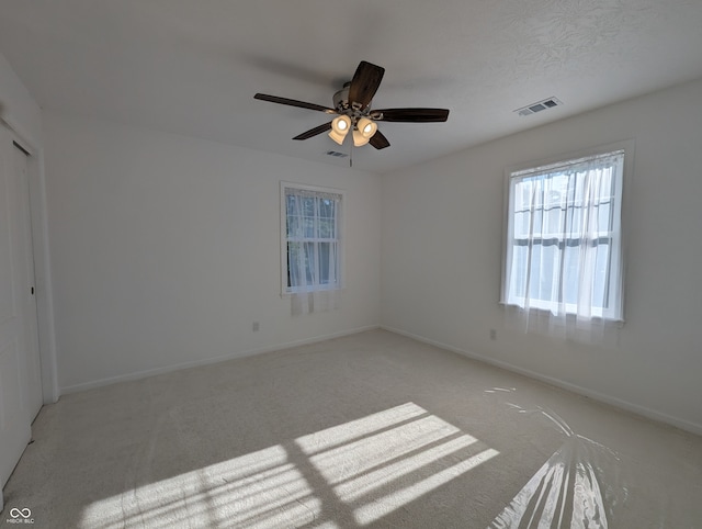 interior space with carpet flooring and ceiling fan