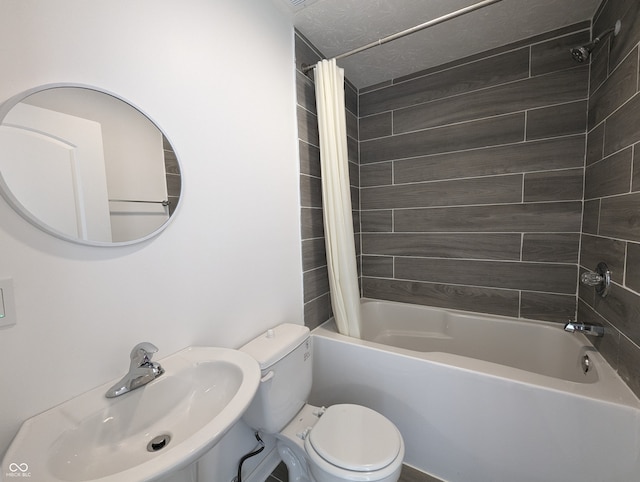 full bathroom with sink, shower / tub combo with curtain, toilet, and a textured ceiling