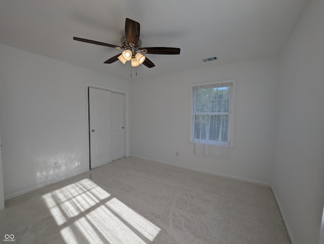 spare room with carpet flooring and ceiling fan