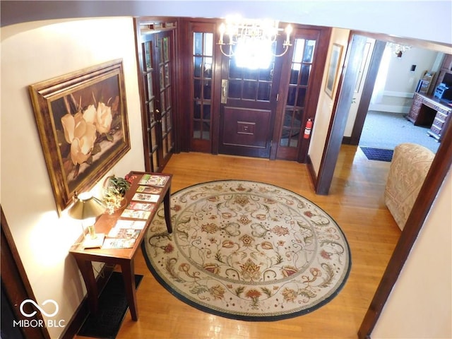 interior space featuring an inviting chandelier and hardwood / wood-style flooring