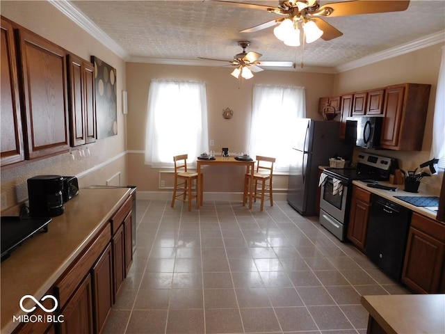 kitchen with dark tile floors, ceiling fan, crown molding, and black appliances