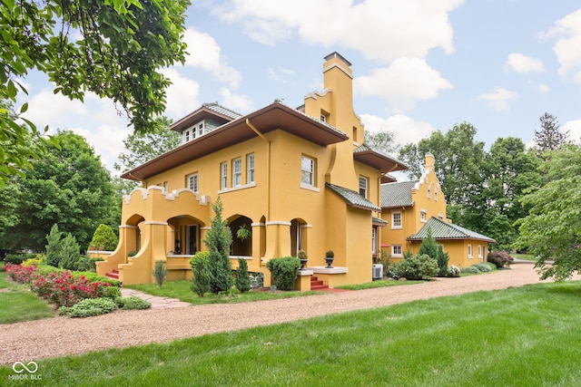 rear view of property featuring a yard