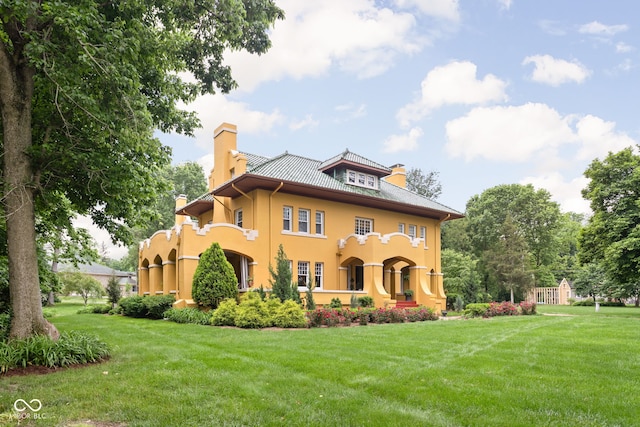 back of property featuring a yard