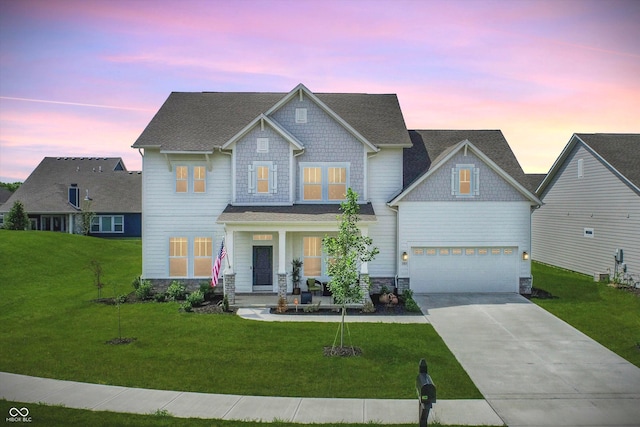 craftsman inspired home with a garage and a lawn