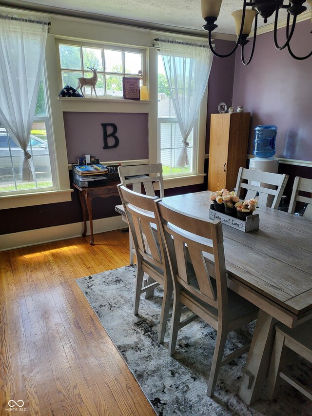 715 5th St, Covington, IN 47932 - dining room featuring hardwood / wood-style floors, an inviting chandelier, and plenty of natural light