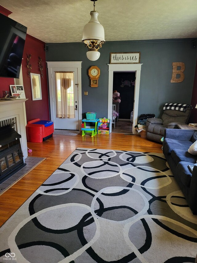715 5th St, Covington, IN 47932 - living area featuring a textured ceiling and wood finished floors