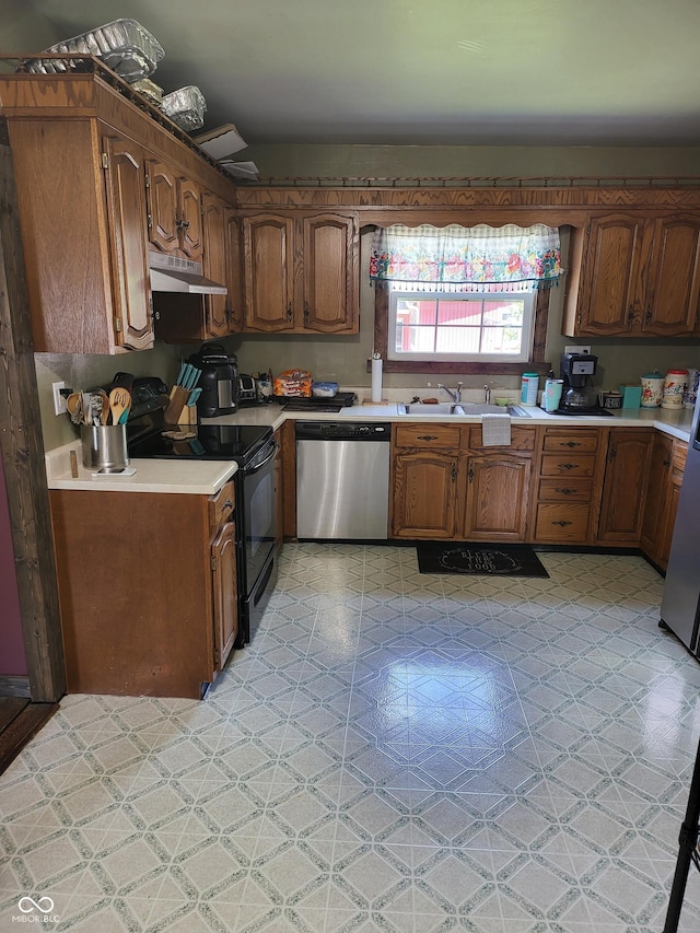 715 5th St, Covington, IN 47932 - kitchen with light countertops, under cabinet range hood, black / electric stove, stainless steel dishwasher, and a sink
