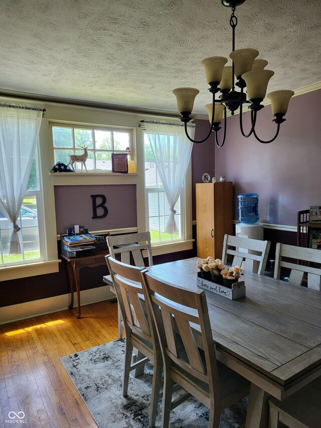 715 5th St, Covington, IN 47932 - dining area featuring an inviting chandelier, hardwood / wood-style floors, and a wealth of natural light