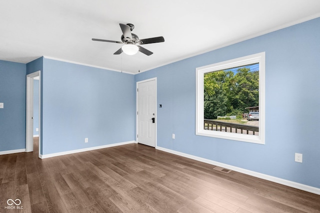 unfurnished room featuring visible vents, baseboards, a ceiling fan, and wood finished floors