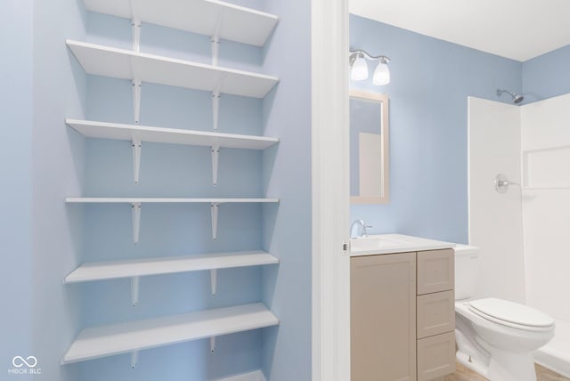 bathroom with a shower, toilet, and vanity