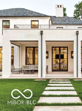 rear view of property featuring a lawn and a balcony