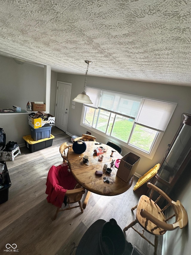 531 N Alton Ave, Indianapolis, IN 46222 - dining area with baseboards, a textured ceiling, and wood finished floors
