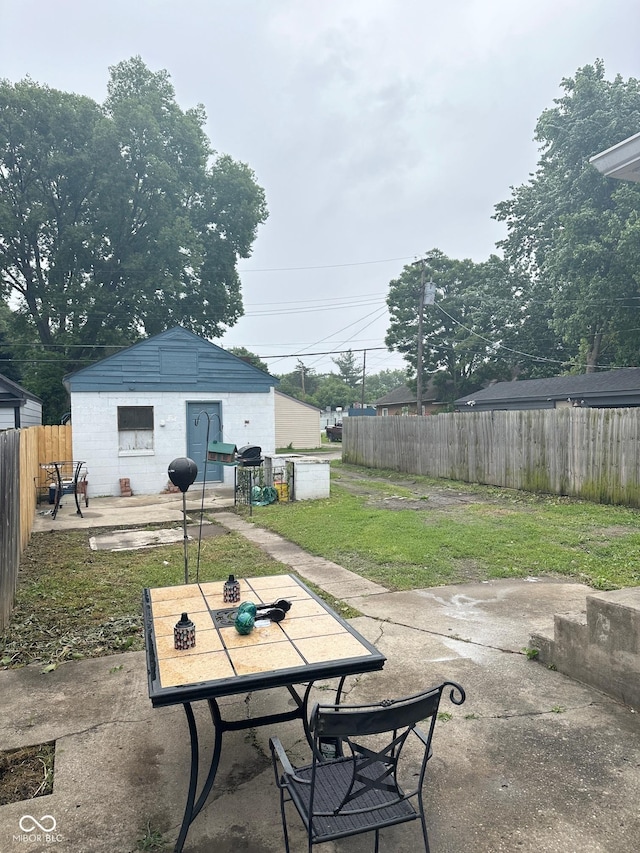 531 N Alton Ave, Indianapolis, IN 46222 - view of patio with a fenced backyard, outdoor dining area, and an outbuilding