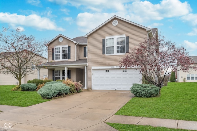 view of property with a front lawn and a garage