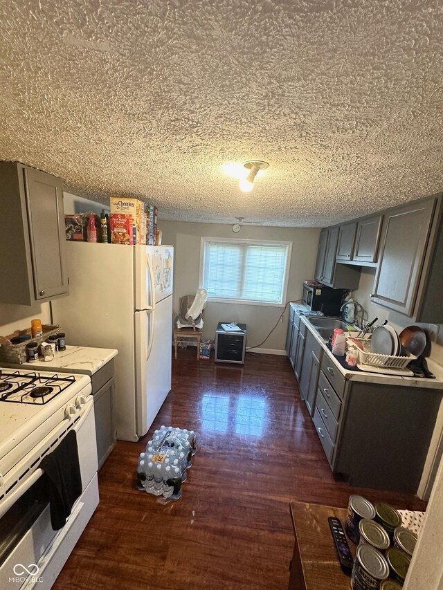 kitchen featuring gray cabinets, dark hardwood / wood-style floors, white range with gas cooktop, and a textured ceiling