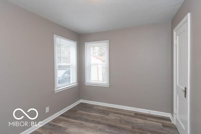 spare room featuring dark hardwood / wood-style flooring