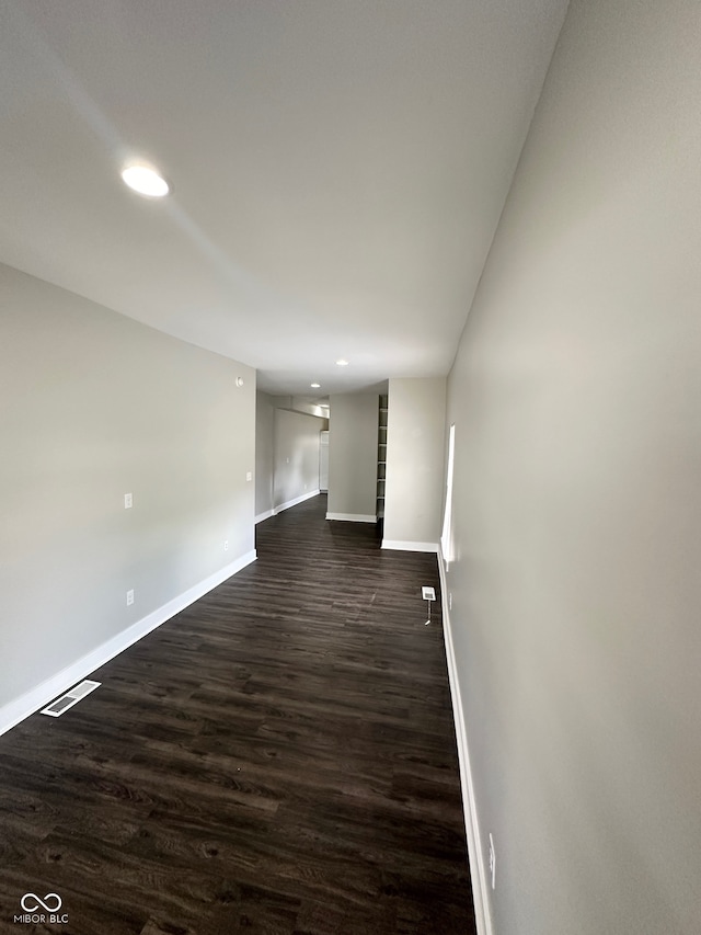 empty room with dark hardwood / wood-style flooring