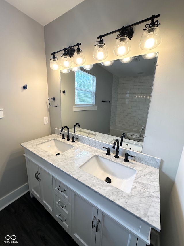 bathroom featuring wood-type flooring and double sink vanity