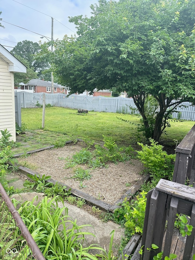 view of yard with a garden and fence private yard